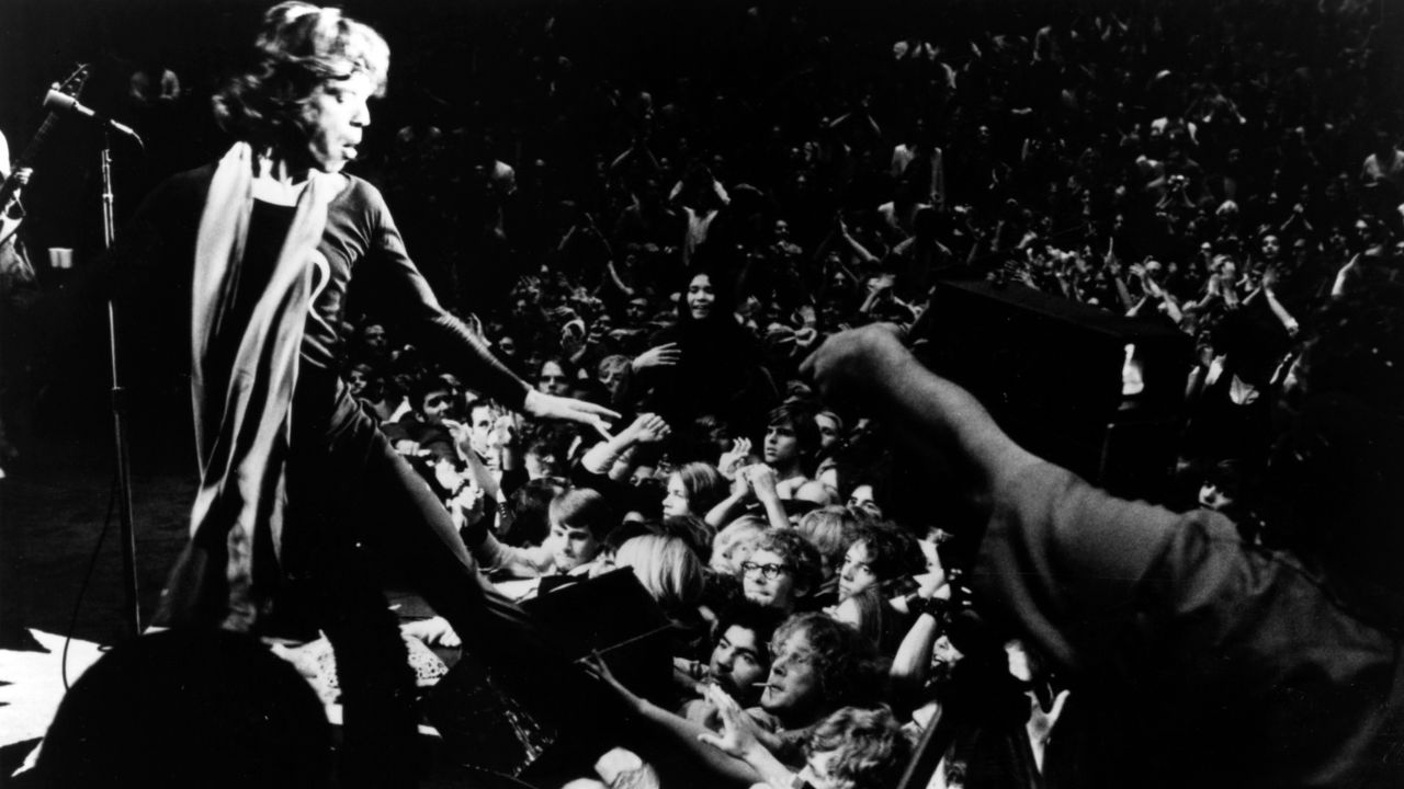 Mick Jagger singing to a packed crowd